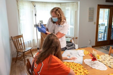 A professional treating a patient at home