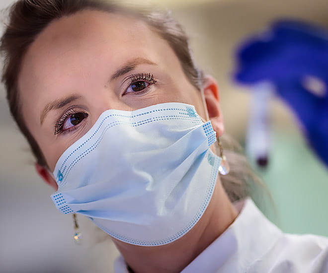 Examining vaccine prior to dosage.
