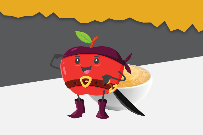 An apple character dressed as a pirate with a sword standing next to a bowl of applesauce.