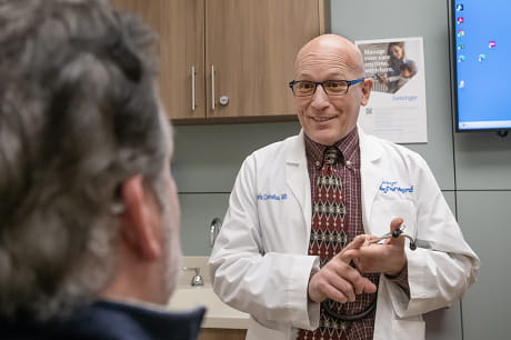 A medical provider meets with a patient.