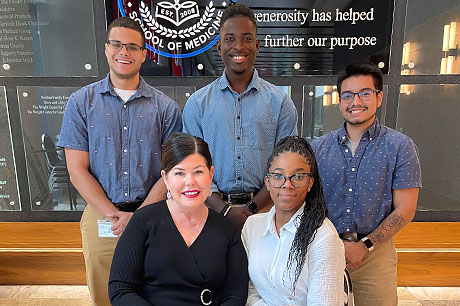 Students in the REACH-HEI program pose for a photo with Maureen Murtha, Geisinger Commonwealth’s director of Pathway Programs.