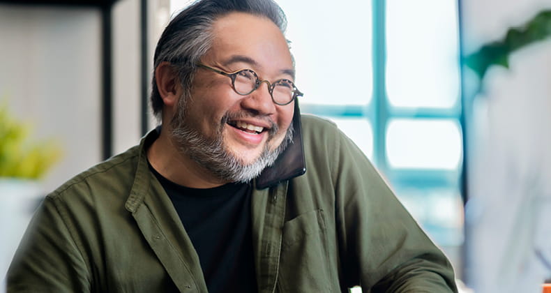 an image of a man on the phone smiling