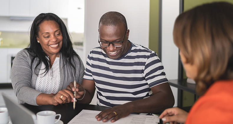 an image of a man and woman talking to an insurance provider