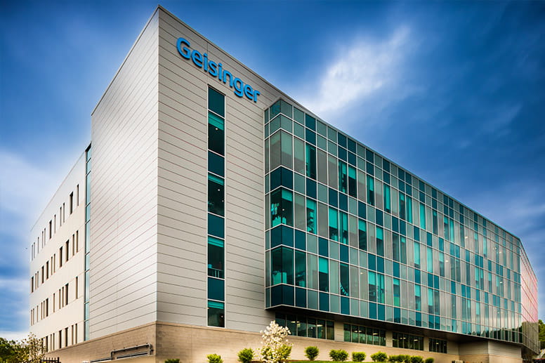 Pharmacist standing at a computer